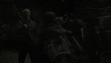 a man holding a gun in a dark area