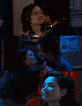 a man and a woman are kissing in a room with a sign that says ' x-ray ' on it