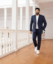 a man in a suit is walking down a hallway