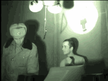 a man in a military uniform is standing next to another man in a room