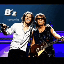 two men singing and playing guitar in front of a banner that says b'z