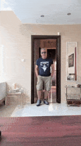a man standing in a doorway wearing a t-shirt that says nothing goes wrong