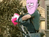 a cartoon character with a pink head is holding a person in his arms