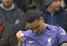 a soccer player wearing a purple jersey with the letters lfc on the front