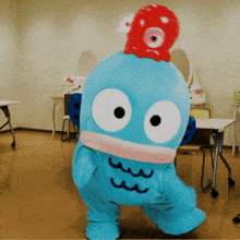 a blue monster with a red octopus on top of it