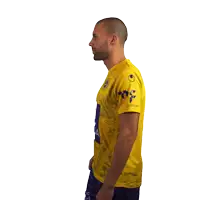 a man wearing a yellow shirt with the word uniqa on the front
