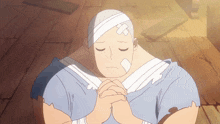 a man with a bandage on his head is praying with his hands folded