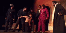 a man in a red suit is surrounded by other men