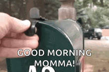a person is opening a mailbox and saying good morning momma .
