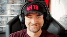 a man wearing a hat that says ah 19 on it