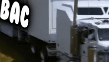a white truck is parked next to a bac sign
