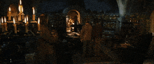 a group of people standing around a table in a room with a sign that says ' chamber of secrets '