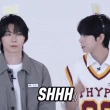 two young men are standing next to each other and one of them has a hype jersey on