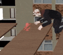 a man in a suit is kneeling down on a wooden staircase