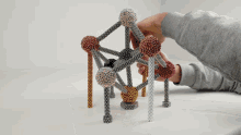 a person is playing with a toy made of magnets and balls