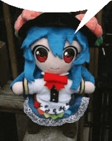 a stuffed doll with blue hair and red eyes is standing on a wooden shelf .
