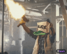 a man is holding a torch and a box that says gator on it