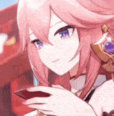 a close up of a girl with pink hair holding a cell phone .