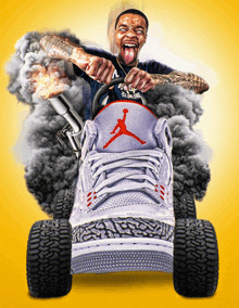 a man in a black shirt is driving a jordan shoe with smoke coming out of it