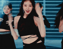 a woman wearing a black crop top is dancing