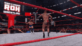 two wrestlers are in a ring with a ring of honor sign behind them