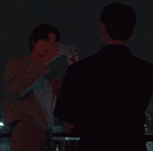 a man is taking a picture of another man with a camera .