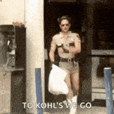a man in a sheriff 's uniform is carrying a bag and says `` to kohl 's we go ''
