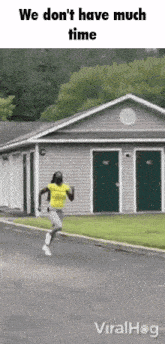 a man in a yellow shirt is running in front of a house that says we don t have much time