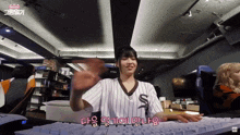 a girl wearing a white and brown striped shirt with the letter s on it