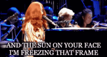 a woman singing into a microphone with the sun on your face i 'm freezing that frame