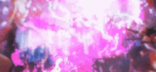 a blurry picture of a crowd of people dancing in a club with a pink background .