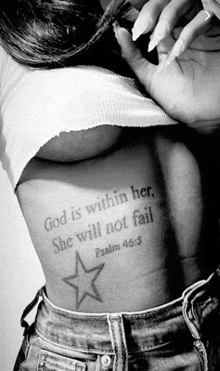 a woman has a tattoo on her back that says god is within her