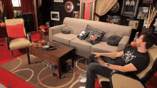 a man sits in a chair in a living room with a couch and a table
