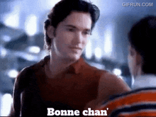 a man is talking to another man with the words bonne chan ' on the bottom