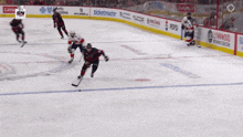 a hockey game is being played on a ice rink with advertisements for pepsi and ticketmaster