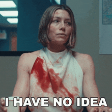 a woman in a bloody shirt is sitting in front of a sign that says i have no idea