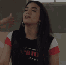 a woman wearing a t-shirt that says " you are just dream dre "