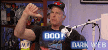 a man is giving a thumbs down sign in front of a microphone with the words boo dark web on the bottom