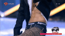 a man 's torso is shown with a supreme waistband