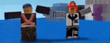 a couple of lego figures are standing next to each other in a video game .