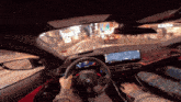 a person is driving a car with a steering wheel