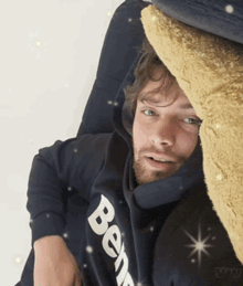 a man wearing a black hoodie with the word berg written on it