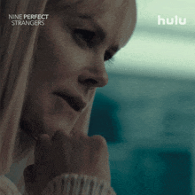 a close up of a woman with the words nine perfect strangers behind her