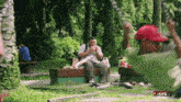 a man sitting on a bench in a park with the word full on the bottom right corner