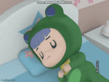 a cartoon character wearing a frog costume laying on a bed