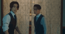 a man is standing behind a curtain in a room with a picture on the wall .