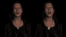 a man wearing a black leather jacket and a necklace with a dog tag on it