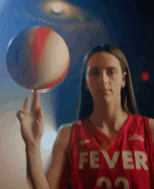 a woman in a red fever jersey holds a basketball in her hand
