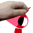 a close up of a person 's hand holding a pink and red cartoon character .