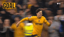 a soccer player wearing a yellow jersey that says debet